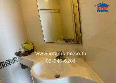 Bathroom with mirror, sink, and towel rack