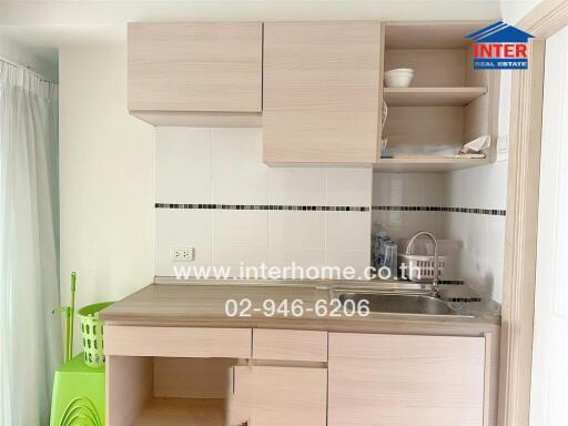 Modern small kitchen with wooden cabinets and integrated sink