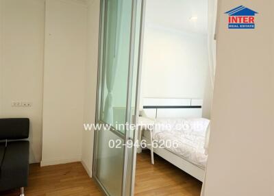 Bedroom with sliding glass door and white bedding