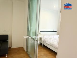 Bedroom with sliding glass door and white bedding