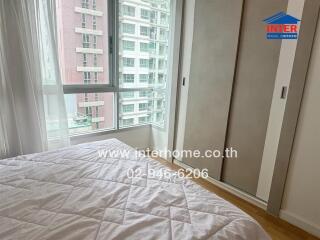 Bedroom with large window and closet