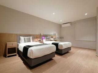 Spacious bedroom with two single beds and modern furnishings