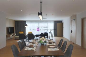 Modern living and dining area with large windows