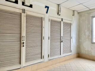 Corridor with shutter doors and large window