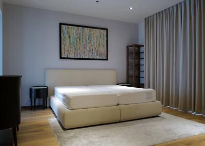 Modern bedroom with large bed and abstract painting