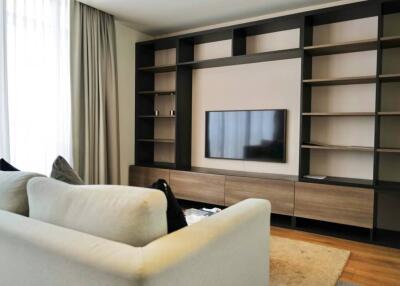 Modern living room with wall-mounted TV and built-in shelving