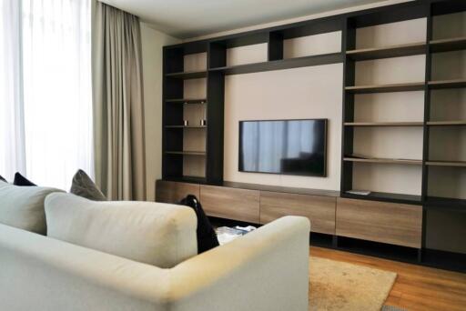 Modern living room with wall-mounted TV and built-in shelving