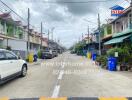 Residential street with houses, cars, and infrastructure