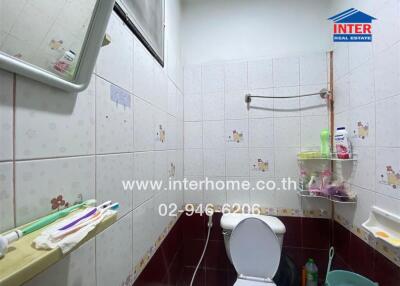 Bathroom with tiled walls and toilet