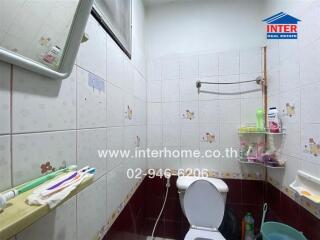 Bathroom with tiled walls and toilet