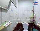 Bathroom with tiled walls and toilet