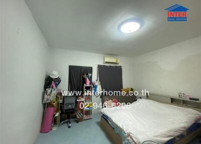 Spacious bedroom with air conditioning, desk, and ample lighting