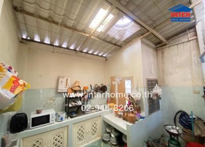 Small kitchen area with ceiling light and various kitchen items