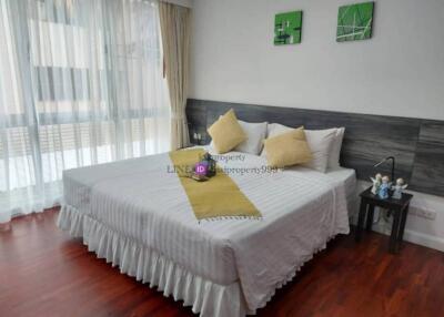 Bedroom with large bed and natural light