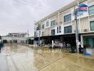 Three-story residential building on a rainy day