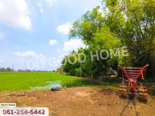 Scenic view of a field with nearby trees and farming equipment