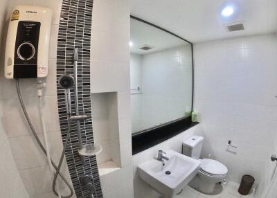 Modern bathroom with shower and large mirror