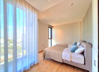 Bright and spacious bedroom with two beds and large windows