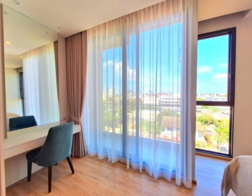 Bright bedroom with large windows and vanity table