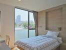 Modern bedroom with large window and city view