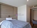 Modern bedroom with wooden accent wall and grey bedding