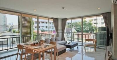 Modern living room with large windows and balcony