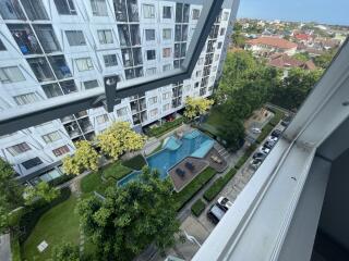 View from window of building over garden and pool area