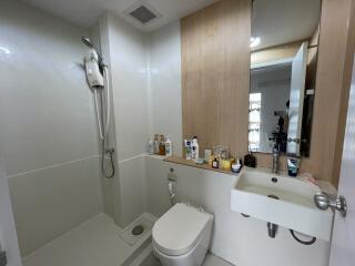 Modern bathroom with shower, toilet, and sink