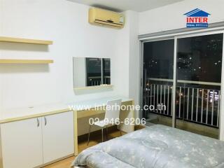 Bedroom with desk, mirror, and sliding glass balcony door