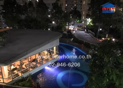 Outdoor view of a building with a pool and surrounding landscape at night