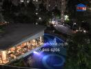 Outdoor view of a building with a pool and surrounding landscape at night
