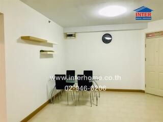 Dining area with wall clock and shelves