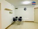 Dining area with wall clock and shelves