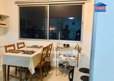 Dining area with table and chairs next to a window