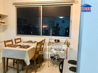 Dining area with table and chairs next to a window