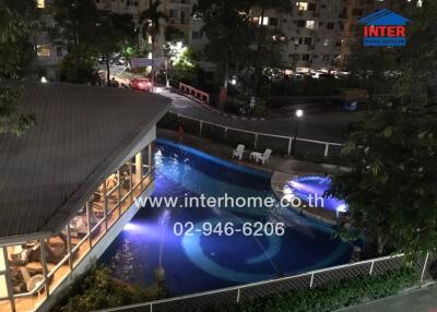 Outdoor view of a property with a swimming pool at night