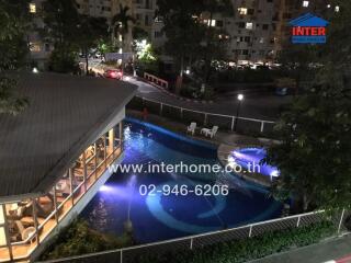 Outdoor view of a property with a swimming pool at night