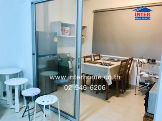 Dining area with a small table set and refrigerator