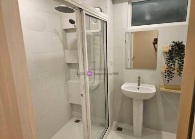 Compact bathroom with shower and sink