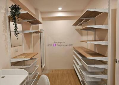 Spacious walk-in closet with organized shelving and drawers