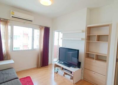 Cozy living room with TV and shelves