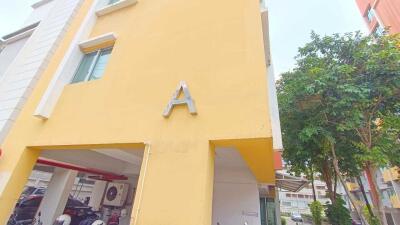 Front view of building with yellow exterior and letter A