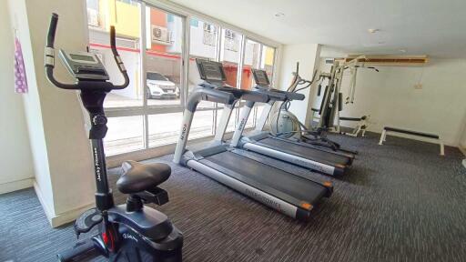 A fitness center with exercise equipment such as treadmills and a stationary bike