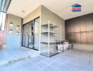 Open backyard patio with shelves, sliding doors, and tiled flooring