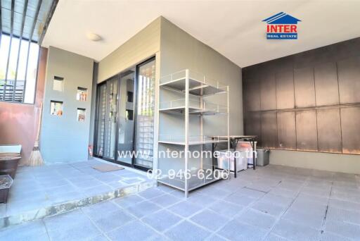 Open backyard patio with shelves, sliding doors, and tiled flooring