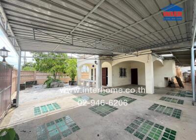 Spacious covered outdoor area with partially tiled floor