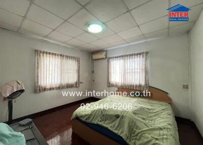 Bedroom with bed, curtains, and air conditioning