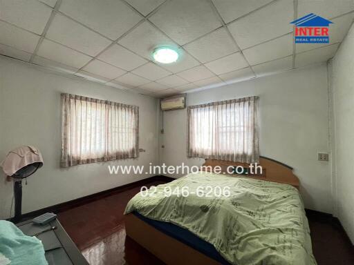Bedroom with bed, curtains, and air conditioning