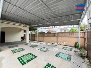 Covered patio area with tiled floor