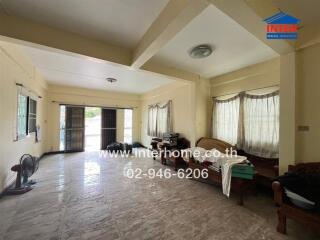 Spacious main living area with multiple windows and minimal furnishings